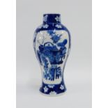 Chinese Kangxi style blue and white baluster vase painted with flowers and shrubs to a prunus