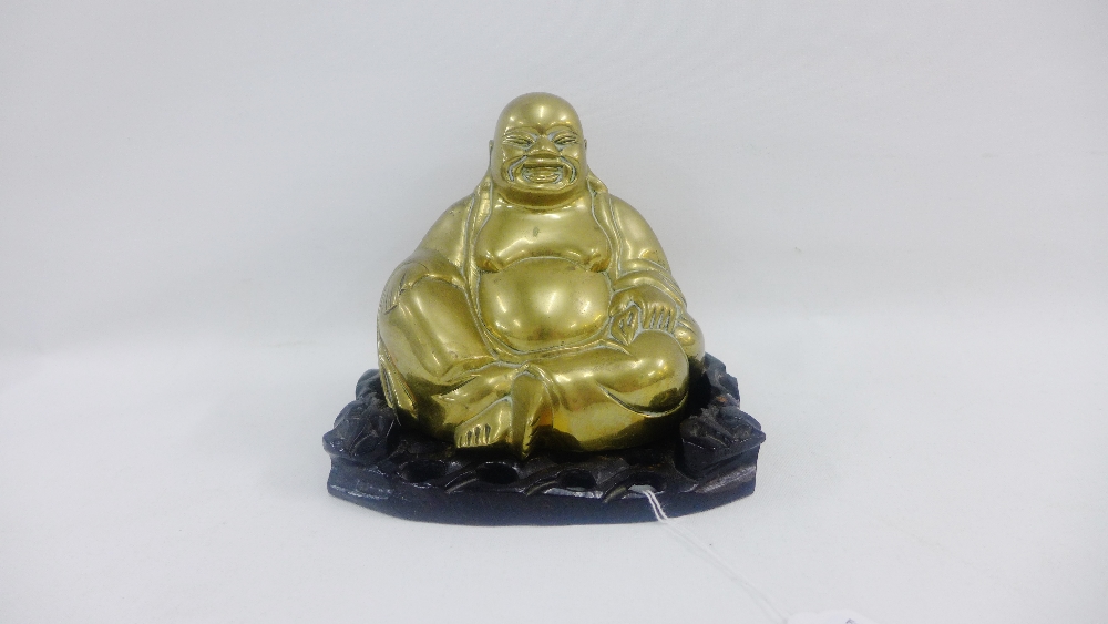 Bronze hollow Buddha on a hardwood stand, 15cm high