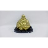 Bronze hollow Buddha on a hardwood stand, 15cm high