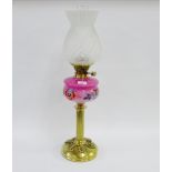 Hinks brass oil lamp with pink opaque glass well, painted with enamel flowers with a moulded glass