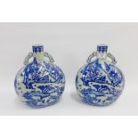 Pair of modern blue and white moon flasks with landscape patterns, 35cm high, (2)
