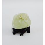 Small carved jade of nuts and flowers, on a hardwood stand, height overall 6cm