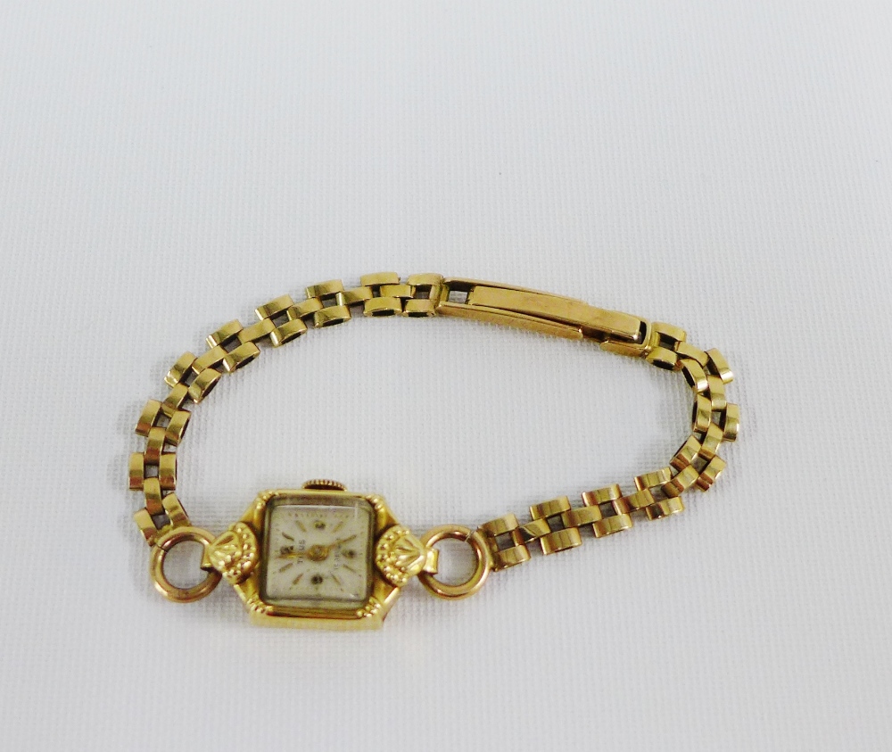 Lady's Titus 17 Jewels wristwatch, case stamped 14k, on a 9 carat gold bracelet strap