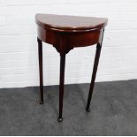 Mahogany foldover demi lune table, on turned tapering legs with pad feet, 72 x 48cm