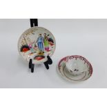 18th century porcelain teabowl and saucer together with another with Chinese figures, (3)