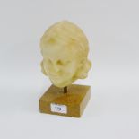 Faux stoneware girls head on a square hardstone plinth base, 21cm high