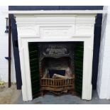 Art Nouveau cast iron fireplace with white painted mantle and surround and green tiles, complete