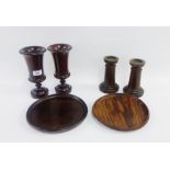 Collection of treen to include a pair of goblets, a pair of candlesticks and two wooden plates,