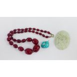 Cherry amber coloured beads, oval jadeite plaque and a turquoise pendant, (3)