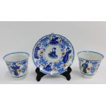 Two blue and white Imari cups and a saucer, circa 19th century, thinly potted and painted with