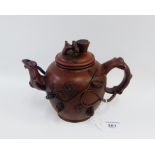 Yixing teapot with fruit and flower decoration with a seal mark to the base, 14cm high