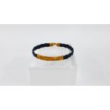 Black leather bracelet with yellow metal mounts, stamped 18k