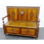 Carved oak settle, with open arms and lift up seat, 104 x 122cm