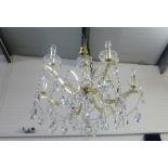 Contemporary six branch glass and faux brass chandelier with hanging lustres and droplets