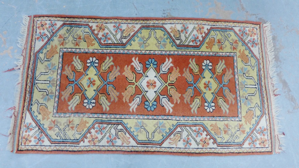 Eastern rug with three medallions and flowerhead border, 136 x 79cm