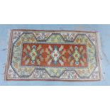 Eastern rug with three medallions and flowerhead border, 136 x 79cm