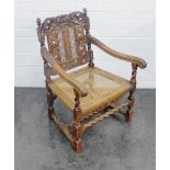 Oak open chair with carved back bearing crown, lions and rosettes, with a Bergere seat, 94 x 58cm