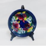 William Moorcroft, for Moorcroft blue glazed shallow dish, tubeline decorated with flowers,