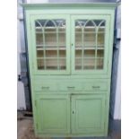 19th century bookcase cabinet painted in institutional green, the top with a pair of lancet glazed