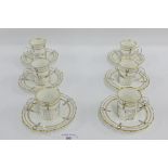 Set of six Aynsley porcelain white glazed coffee cups and saucers with gilt edged rims and black