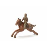 A RARE TERRACOTTA POLO RIDER, TANG DYNASTY (618-907)The skillfully modeled statue with remainders of