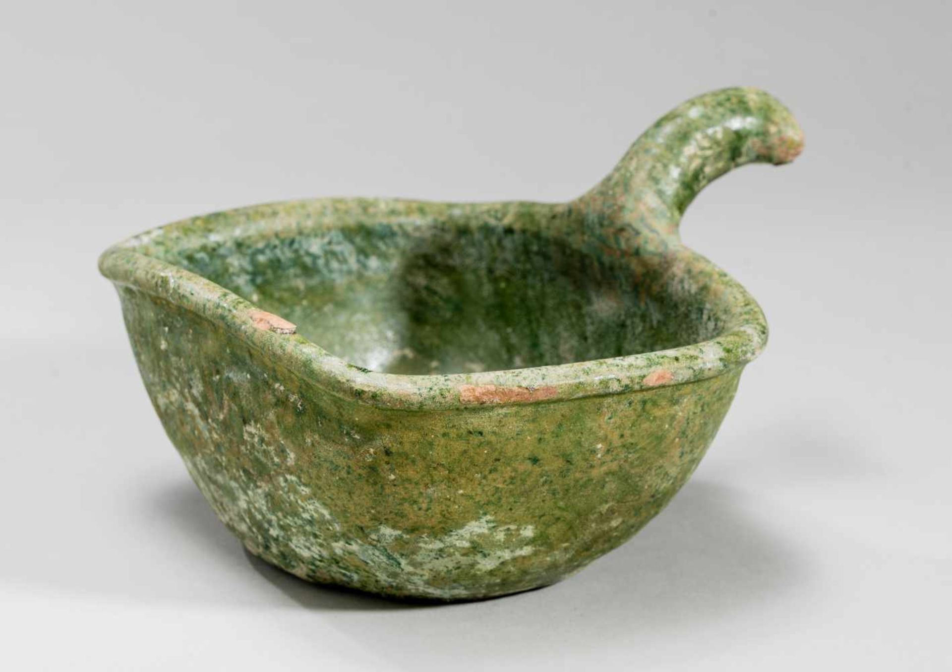 A VESSEL WITH HANDLEGlazed ceramicChina, Han dynasty (206 BC-220 AD)An interesting, if simple, find!