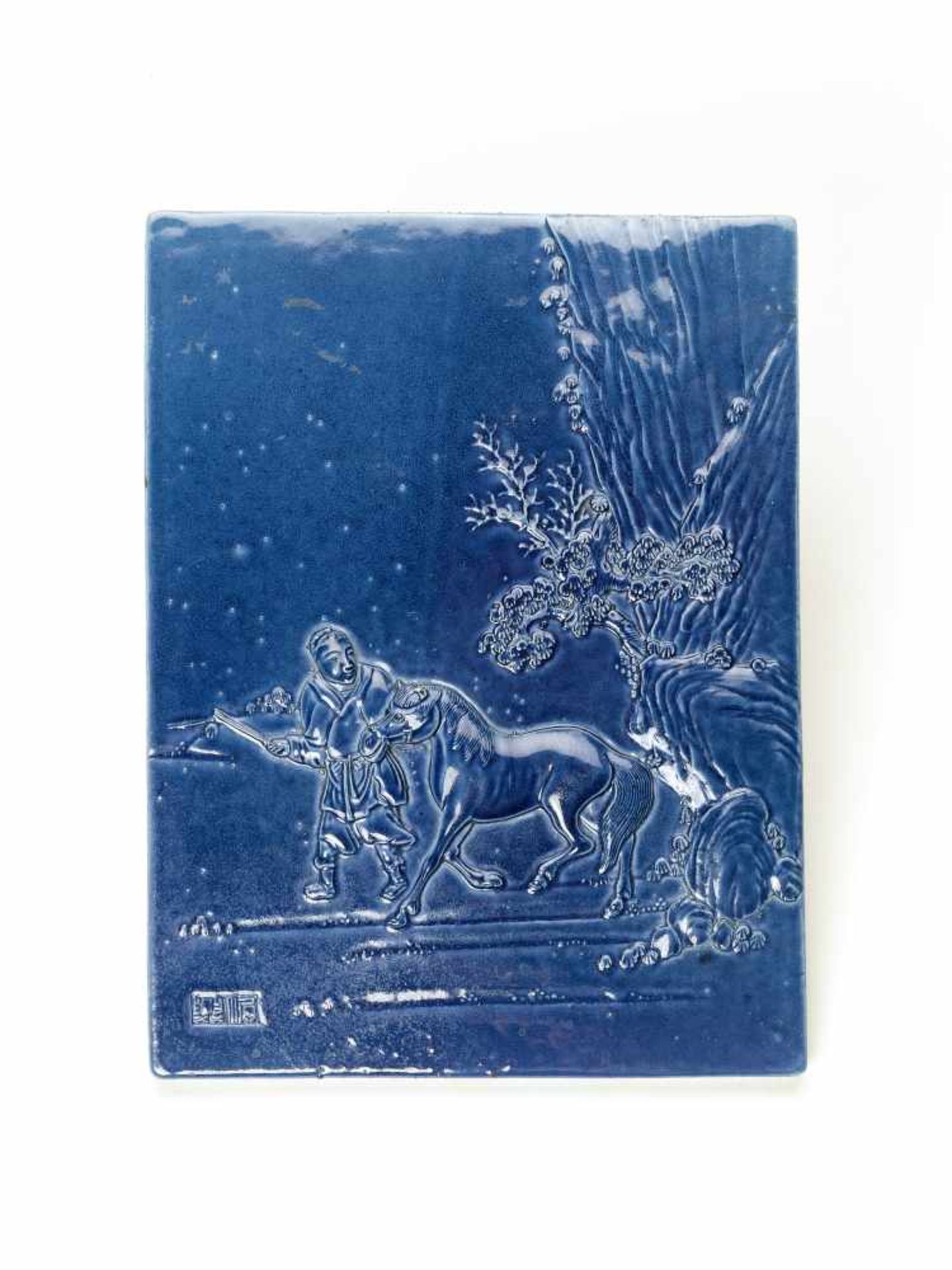 A CHARMING BLUE GLAZED PORCELAIN ROOF TILE DEPICTING A SERVANT WITH HORSEPorcelainChina, 20th