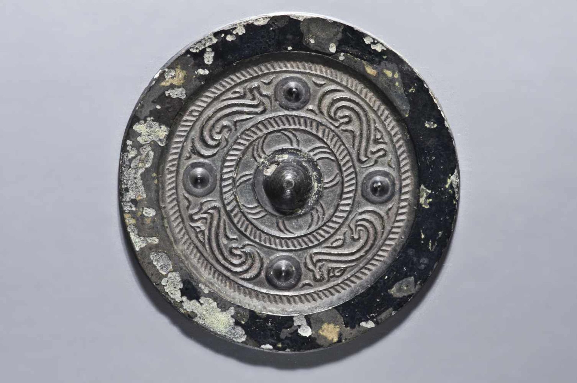 SMALL MIRROR WITH CLOUD DRAGONSBronzeChina, Han dynasty style, possibly laterOf circular form, the