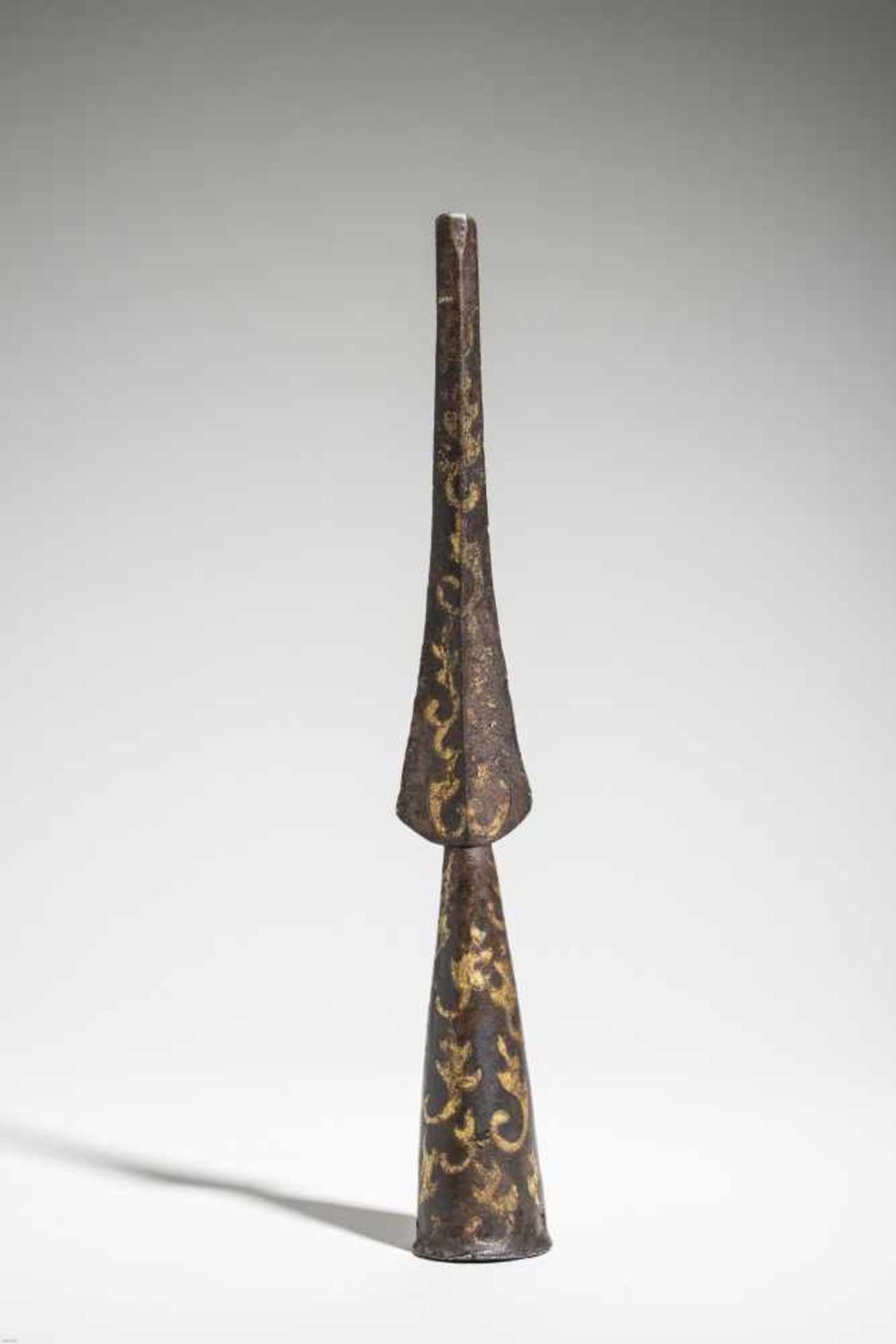 A RARE CAST IRON AND GOLD INLAID HAN DYNASTY SPEARHEADThe gilt inlays depicting an archaic leaves-