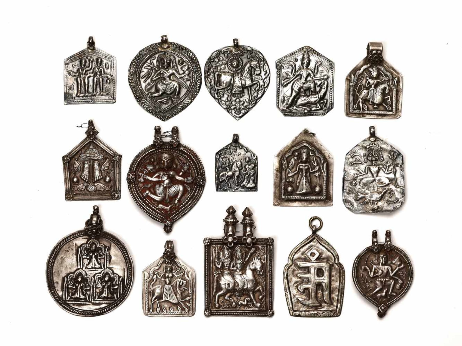 LOT WITH 15 LARGER SILVER AMULETS – INDIA 18th - 19th CENTURY Silver, some with remnants of cold