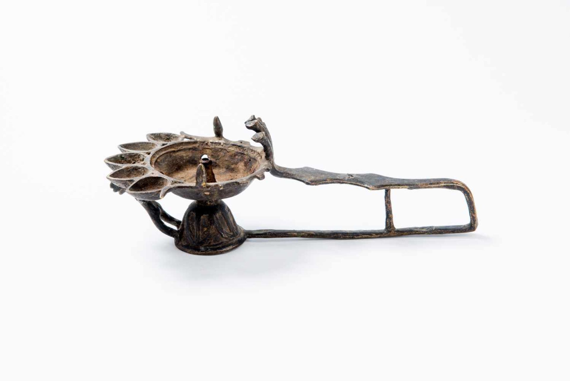 A FIGURAL OIL LAMPBronzeNepal, possibly 19th centuryBell-shaped foot and a long, U-shaped handle, - Image 2 of 4