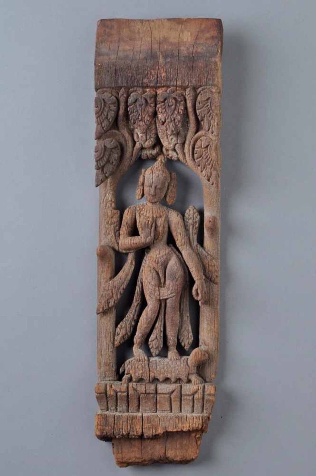 CUT FIGURATIVE DECORATIVE PANELWoodNepal, 19th centuryA deva under two trees with large leaves on