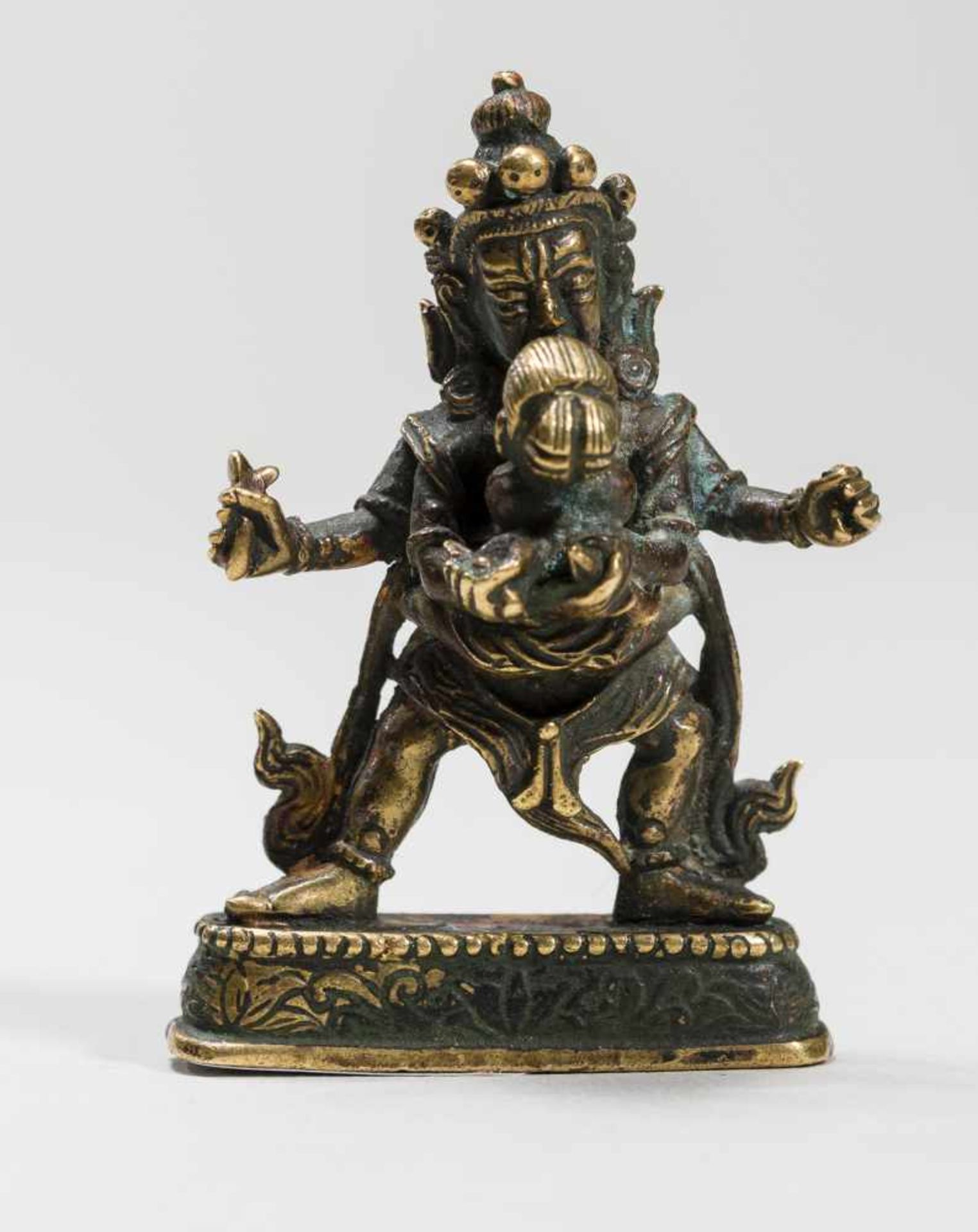 A TIBETAN BRONZE OF A DHARMAPALA IN YABYUM WITH PRAJNABronzeTibet, 19th centuryA four-armed