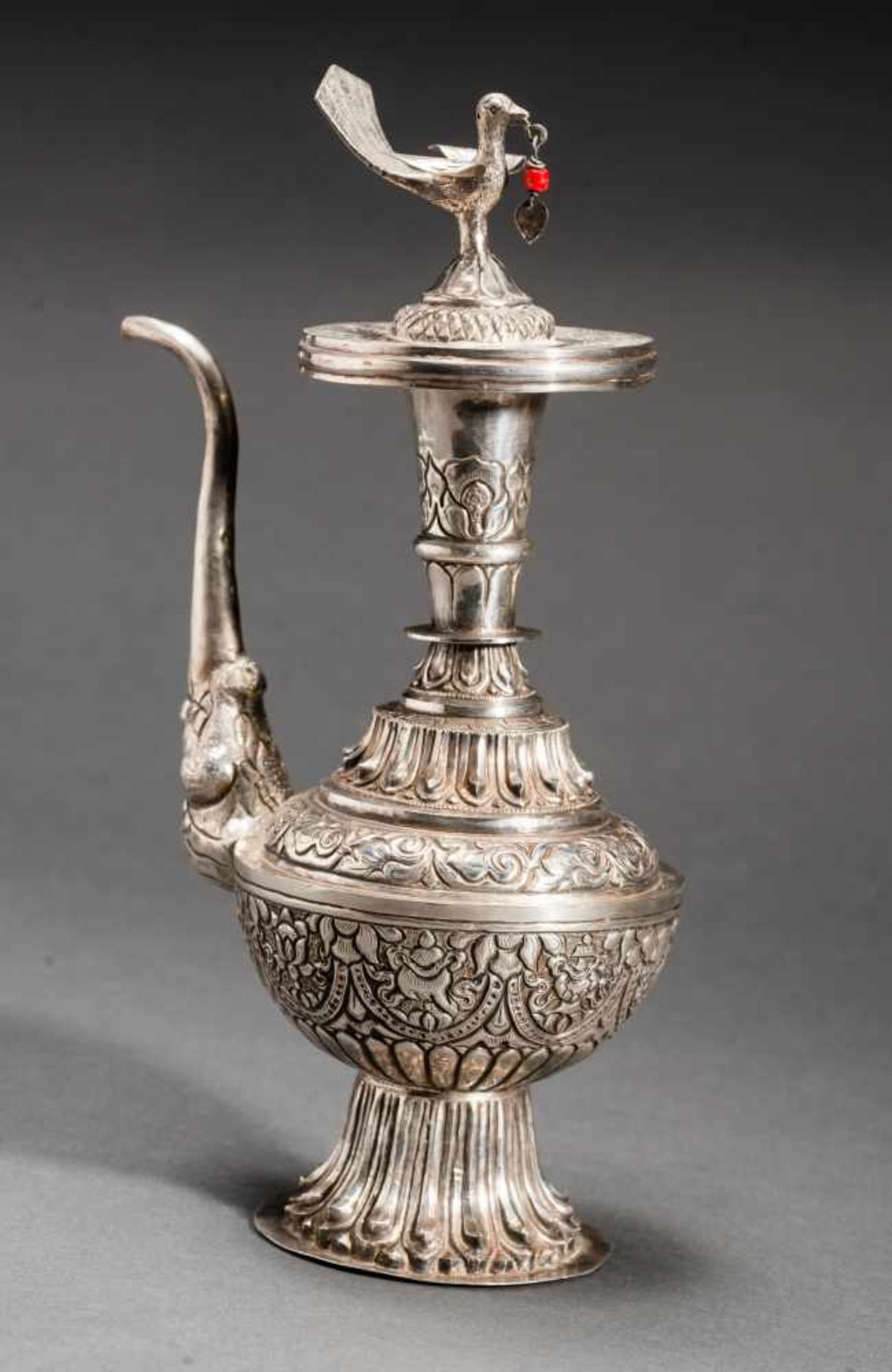 POT WITH MAKHARA AND BIRDWrought silverTibet, late 19th to early 20th centurySlender teapot with