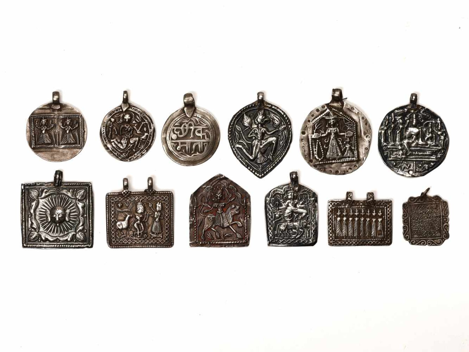 LOT WITH 12 SILVER AMULETS – INDIA 18th - 19th CENTURY Silver, some marked, some with remnants of