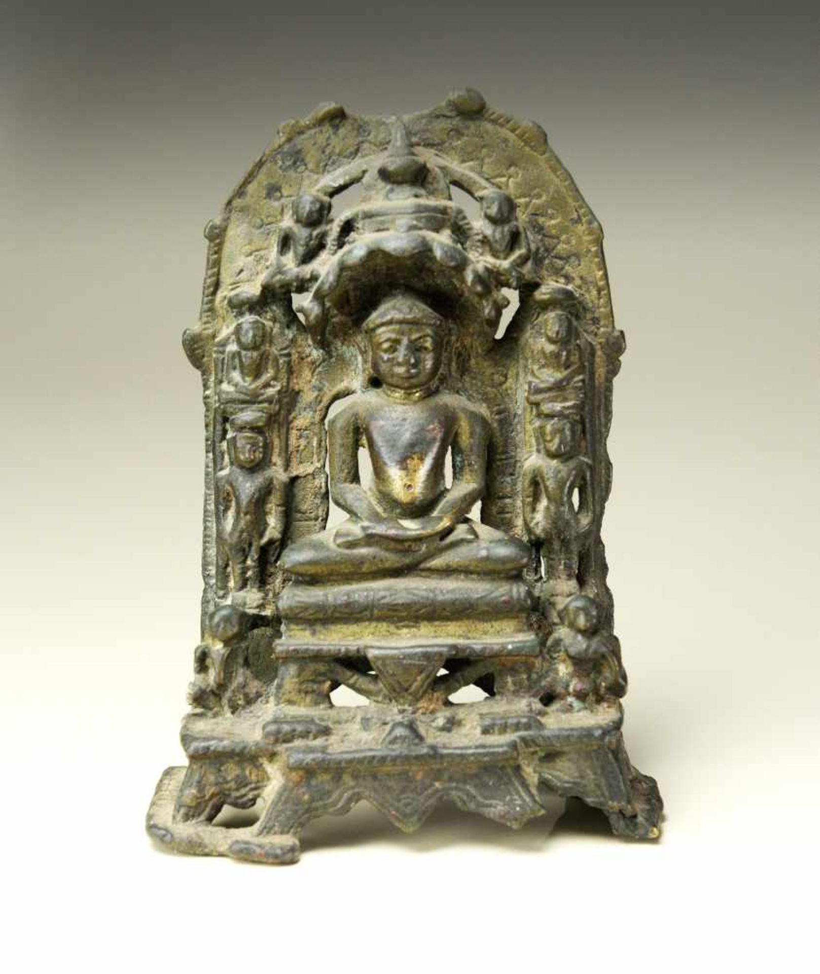 A BRONZE ALTAR WITH THE JAIN DIVINITY TIRTHANKARAYellow bronzeWestern India, c. 15th centuryA