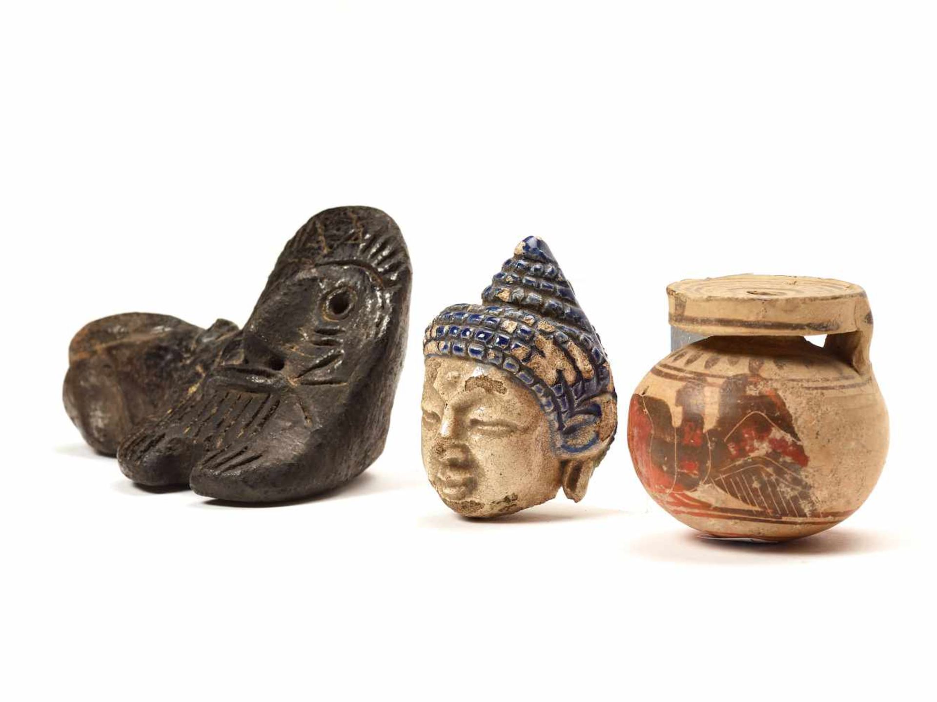 A MIXED LOT OF SMALL TERRACOTTA ITEMSA Chinese ceramic Buddha head, a pipe head of possibly Greek