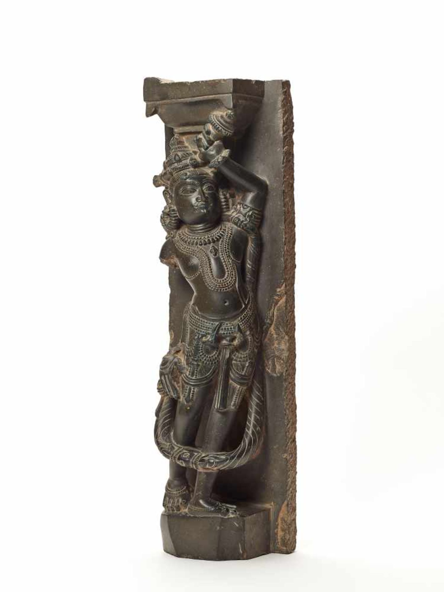 A BLACK STONE STATUE OF A STANDING GODDESS, INDIA ca. 18TH CENTURYThe crowned and bejeweled