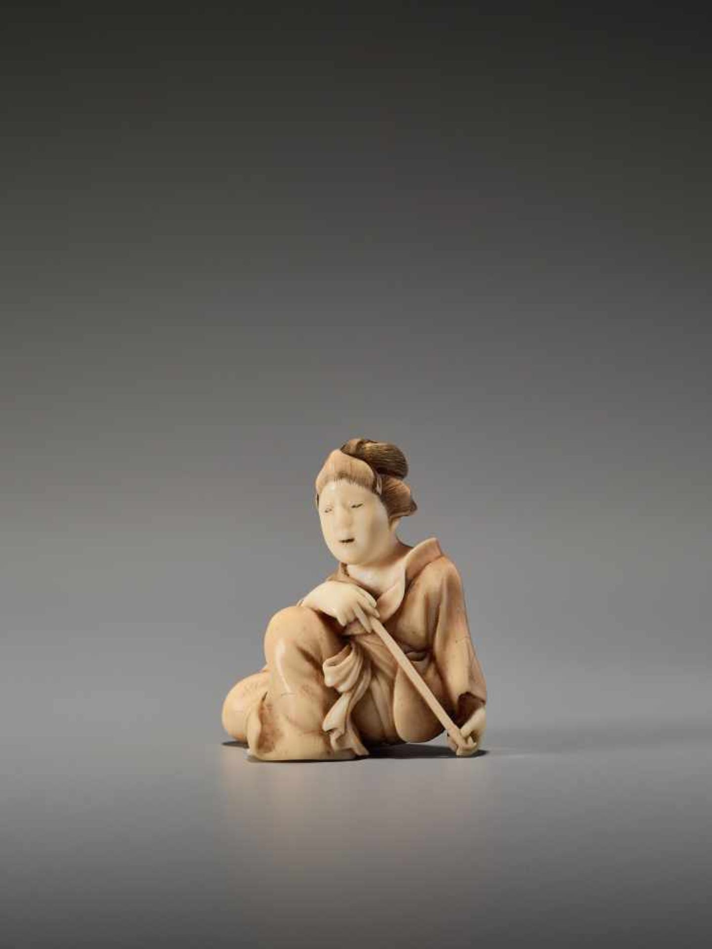 AN IVORY SHUNGA NETSUKE OF A BIJIN WITH PIPE BY KOHOSAIBy Kohosai, ivory shunga netsukeJapan, Osaka,