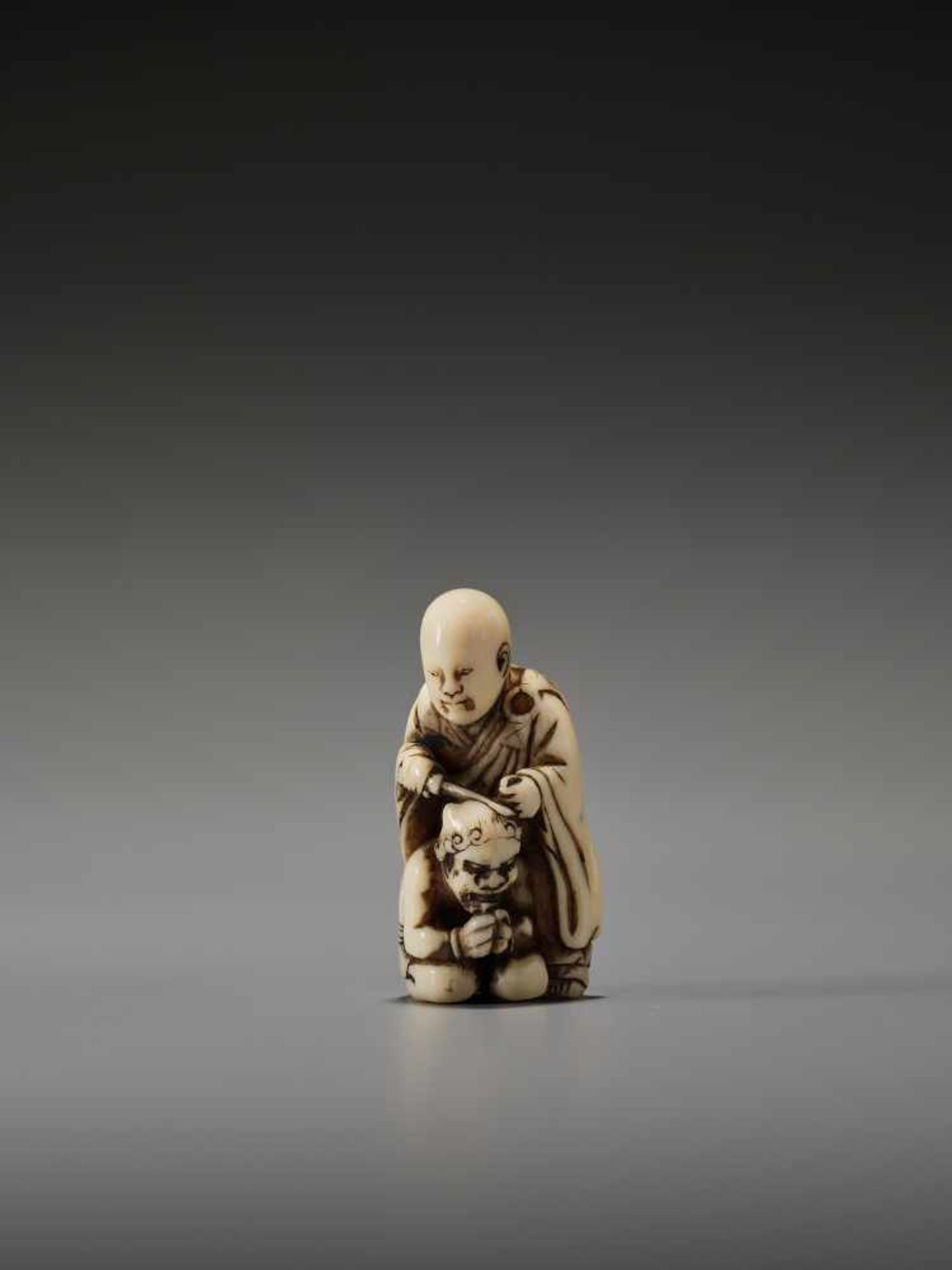 AN IVORY NETSUKE OF A MONK AND REPENTANT ONIUnsigned, Tomochika school, ivory netsukeJapan, mid to