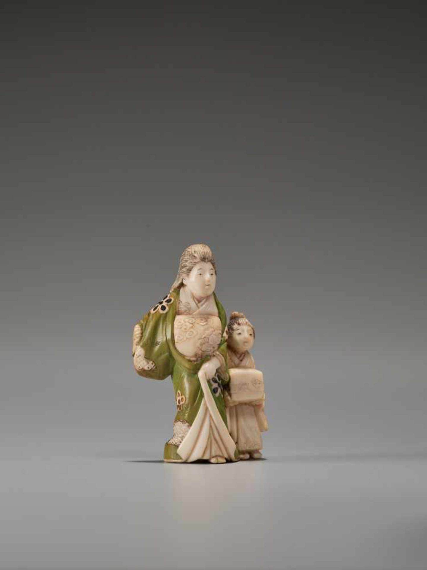 A TOKYO-SCHOOL IVORY NETSUKE OF AN OIRAN WITH A KAMURO BY GYOKUZANBy Gyokuzan, ivory netsuke with