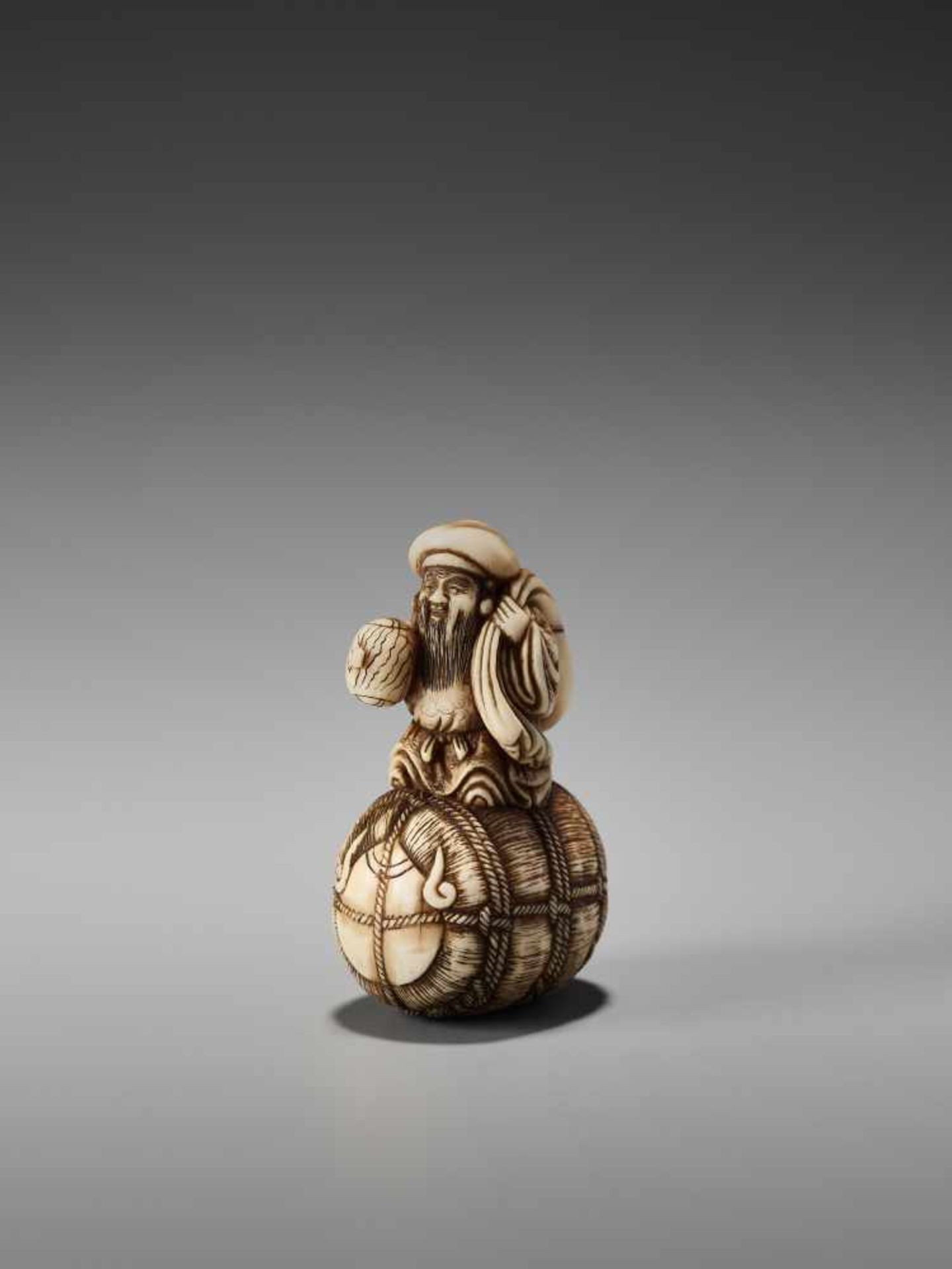 AN IVORY NETSUKE OF DAIKOKU ON A RICE BALE BY RANTEIBy Rantei, ivory netsukeJapan, Kyoto, mid-19th