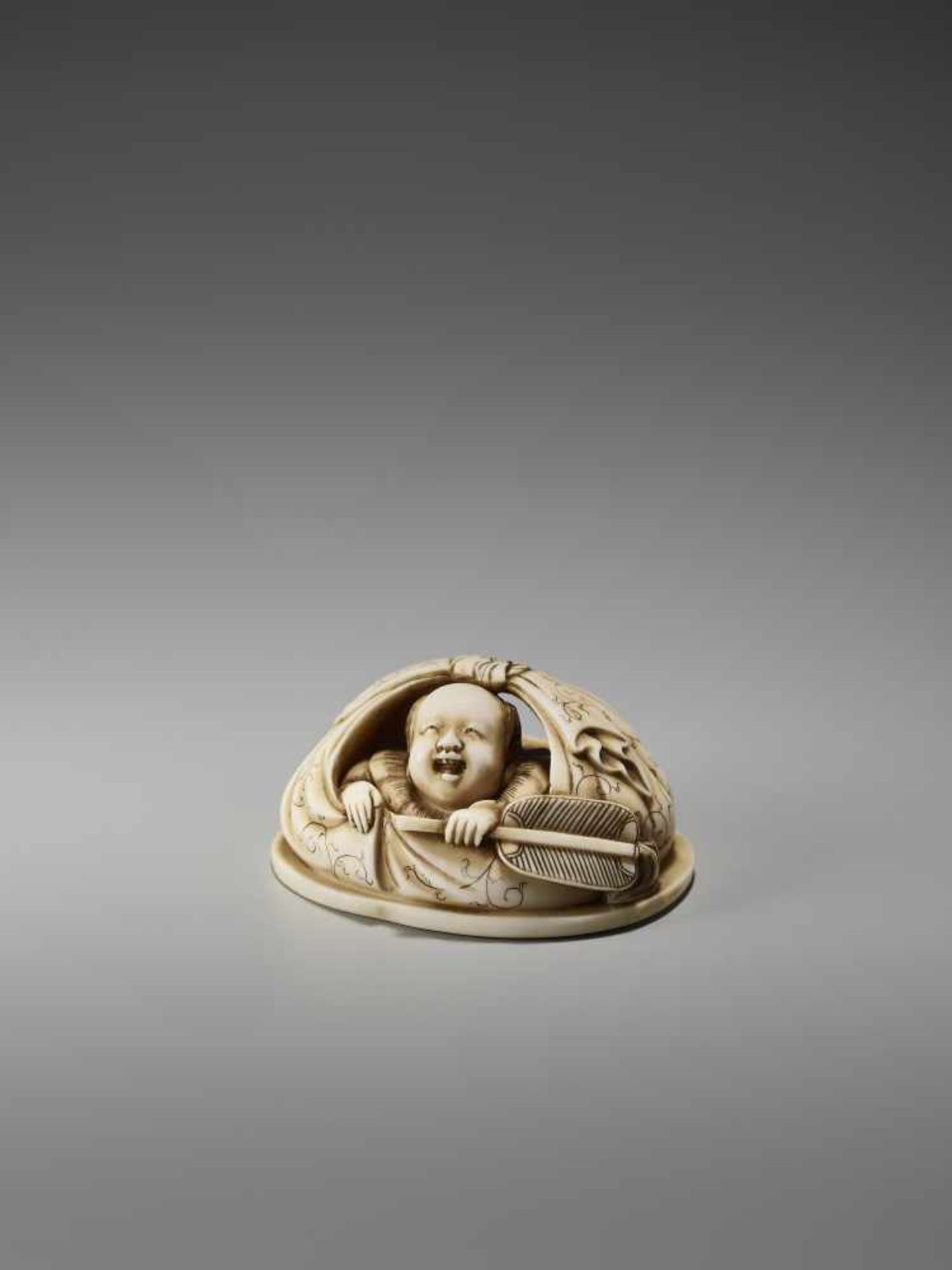 AN IVORY NETSUKE OKIMONO OF A BOY IN HOTEI’S BAGSigned in seal form Tanaka, ivory netsuke-