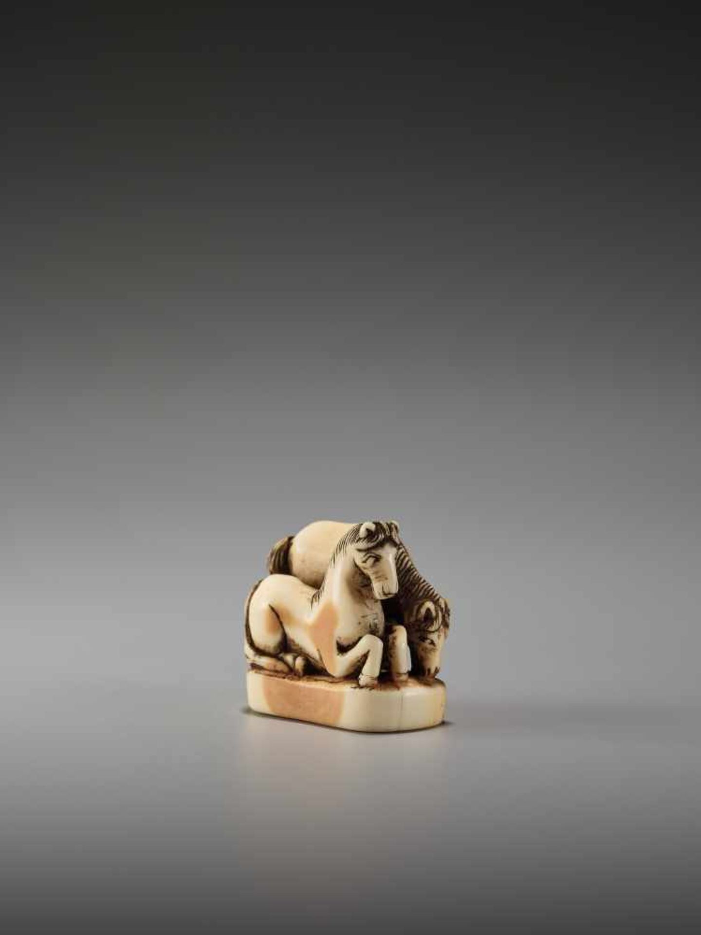 AN IVORY NETSUKE OF TWO HORSES ON A BASEUnsigned, ivory netsukeJapan, early 19th century, Edo period