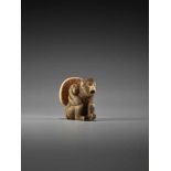 A FINE IVORY NETSUKE OF A MONKEY CARRYING A LARGE MUSHROOMUnsigned, ivory netsukeJapan, 19th