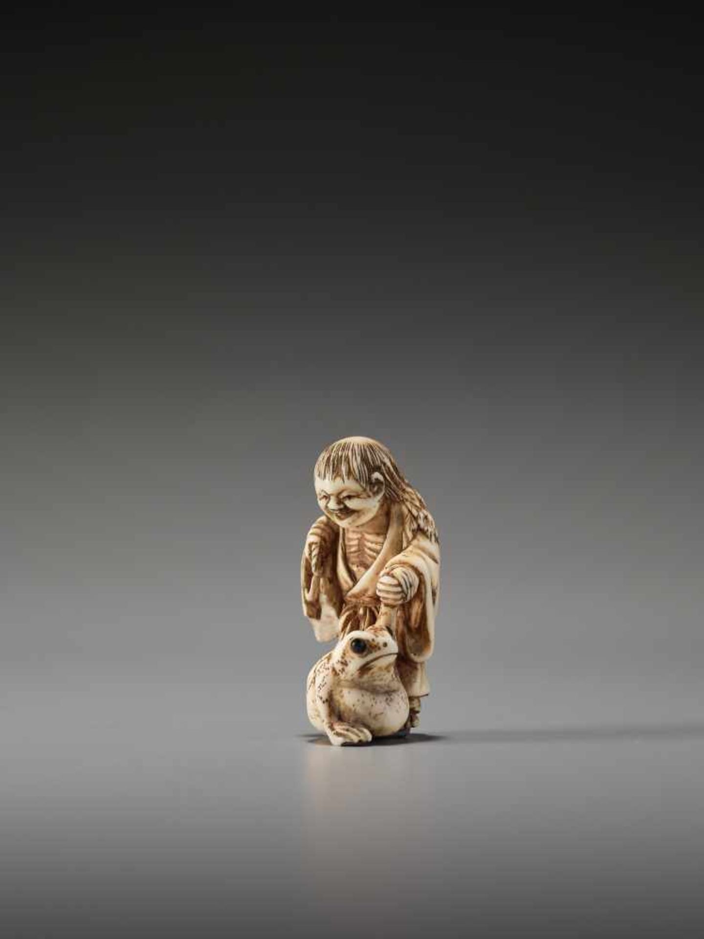 AN IVORY NETSUKE OF GAMA SENNIN WITH LARGE TOADUnsigned, ivory netsukeJapan, 19th century, Edo