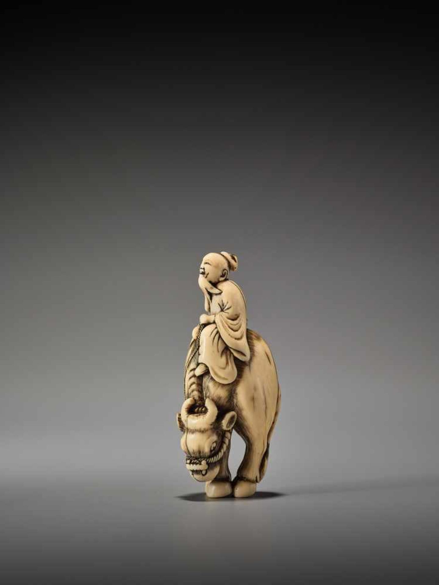 AN IVORY NETSUKE OF ROSHI ON WATER BUFFALOUnsigned, ivory netsukeJapan, 18th century, Edo period (