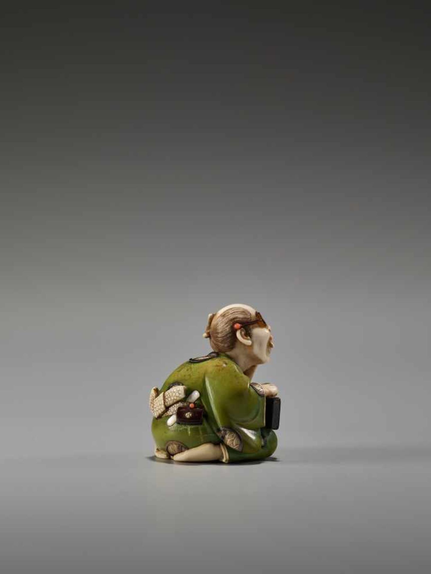 A FINE TOKYO-SCHOOL IVORY NETSUKE OF A MAN WITH GLASSES AND AN ABACUS BY YASUMASABy Yasumasa ( - Image 2 of 9