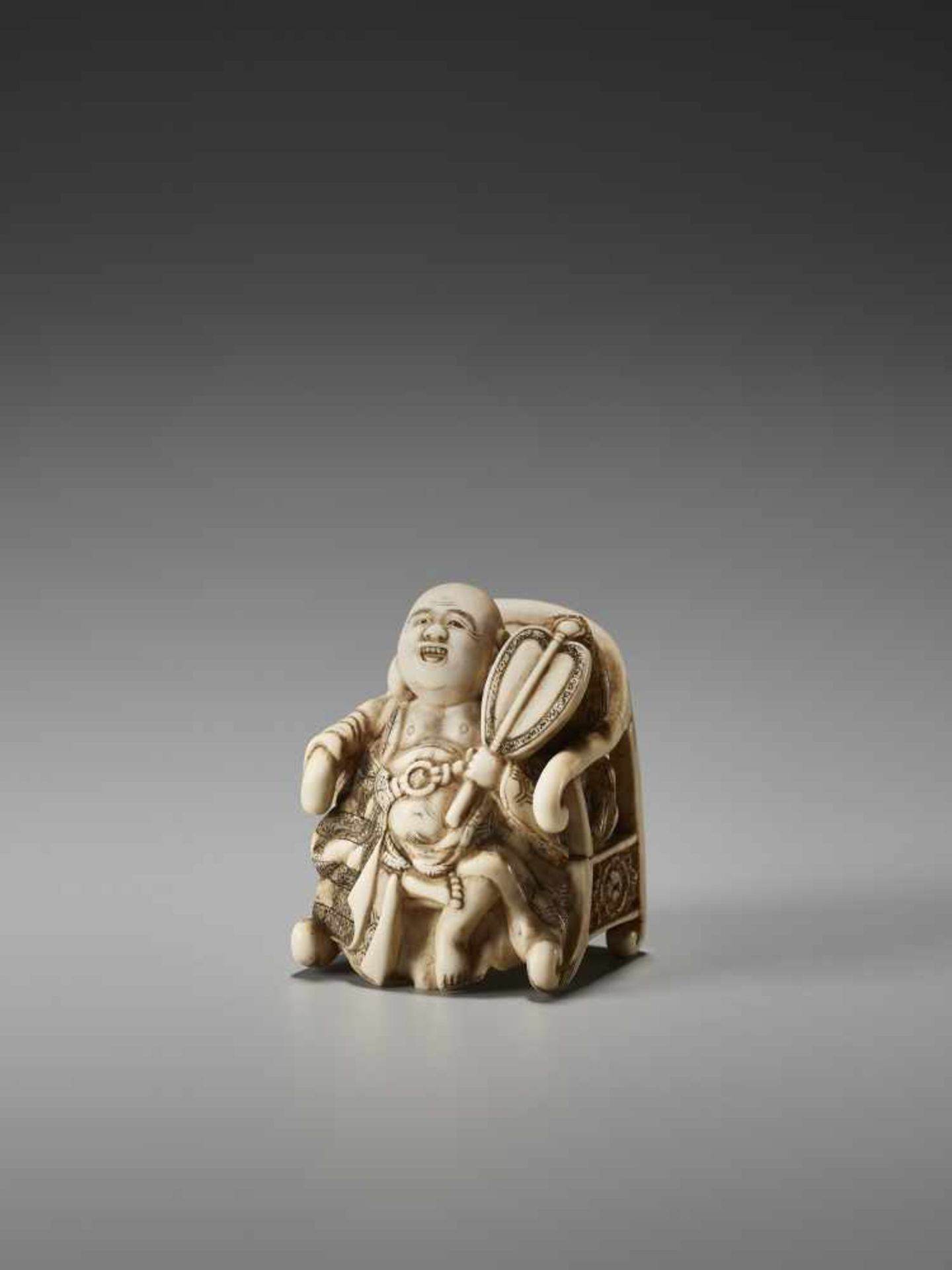 AN UNUSUAL IVORY NETSUKE OF HOTEI ON A THRONE BY CHIKUSAIBy Chikusai, ivory netsukeJapan, mid-19th