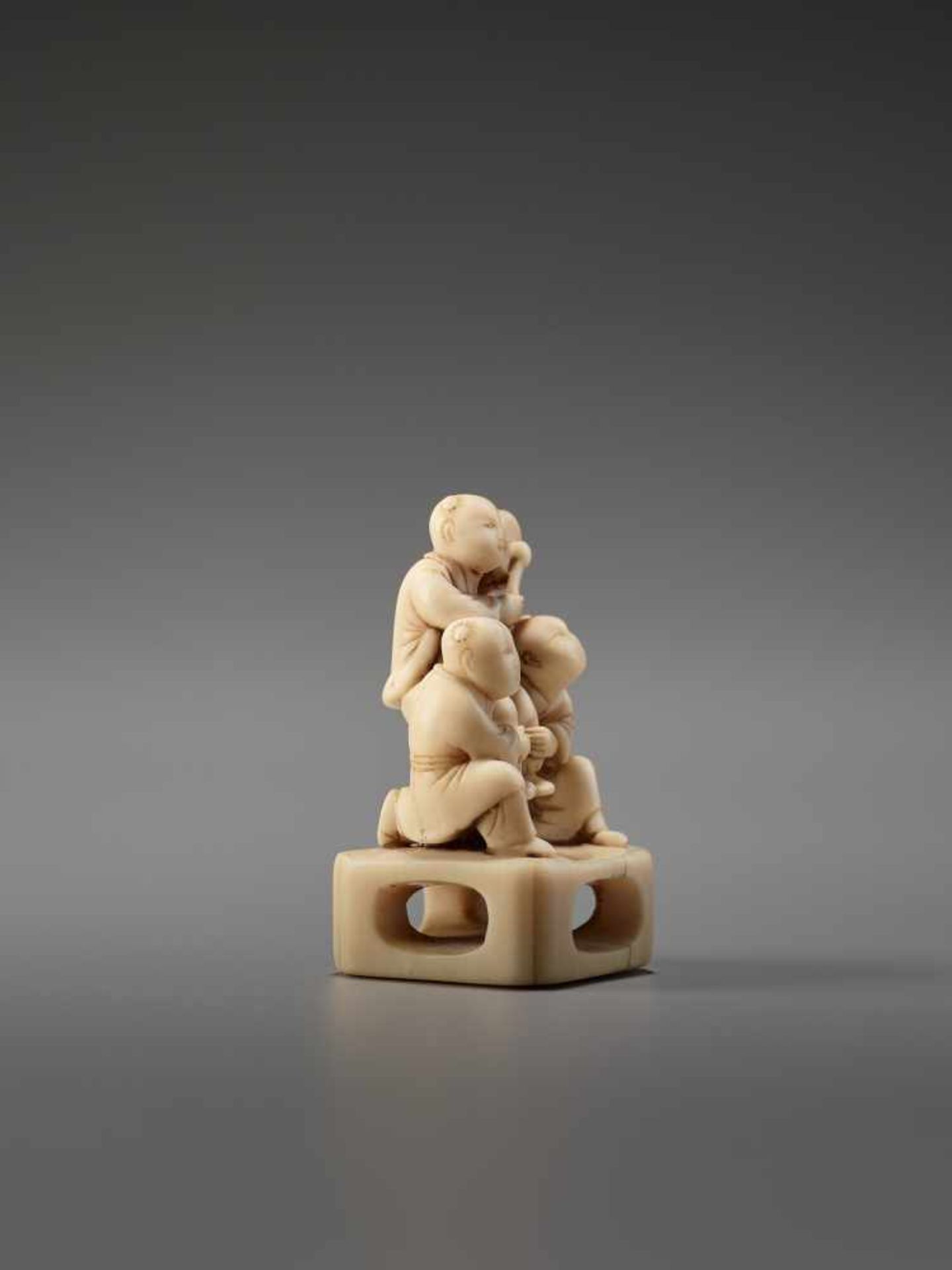 AN IVORY NETSUKE OF THREE CHINESE BOYS AND A DRUMUnsigned, ivory netsukeJapan, late 18th to early - Image 5 of 7